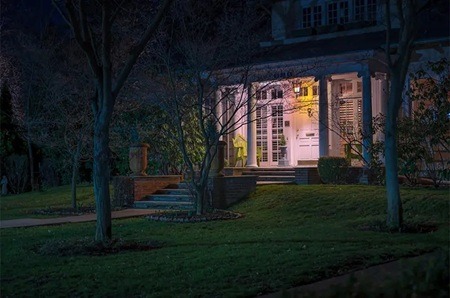 Front porch of a nice home lit up at night